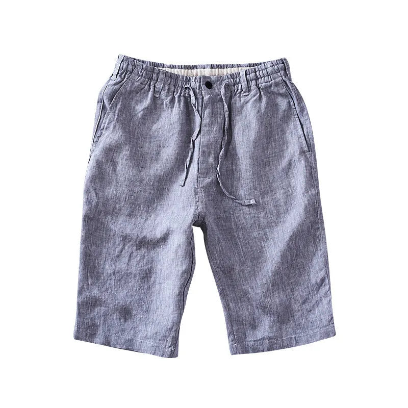 Men's loose-fitting linen capri pants in a light colour, showing the straight-leg style.