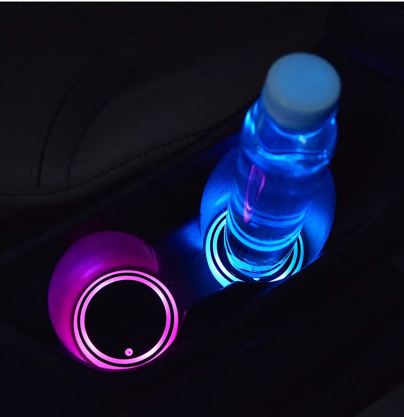 Colourful LED light-up coaster for car cup holder with solar panel and USB cable.
