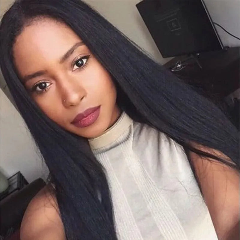 Long straight black synthetic ladies wig with a centre part, displayed on a wig stand.