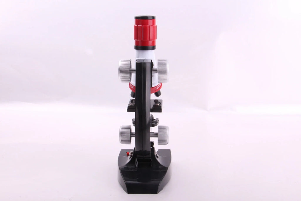 Child biological microscope with LED light, three objective lenses, and coarse focus knob on white background