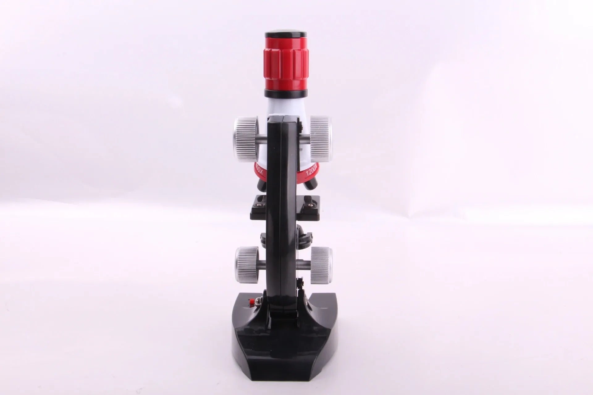 Child biological microscope with LED light, three objective lenses, and coarse focus knob on white background