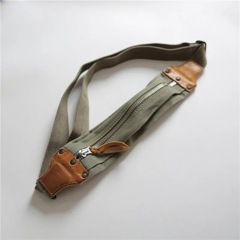 Green military style chest bag with washed canvas exterior and brown Italian leather accents