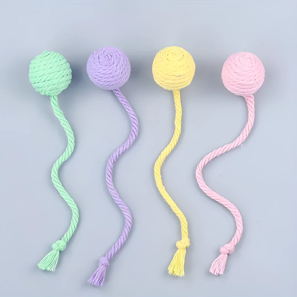Cat toy ball with rope handle in green, pink, purple or yellow colours with internal bell