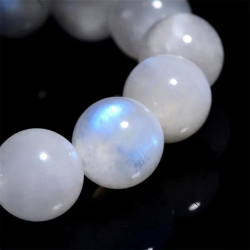 Natural blue moonstone round beads strung on a white cord bracelet.
