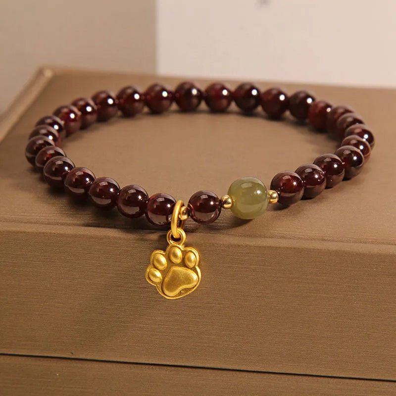Cat's paw garnet crystal bracelet for women showing clear beads with feline charm