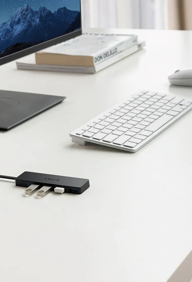 Black Anker 4-port USB 3.0 hub with attached cable, dimensions 30x107 mm.