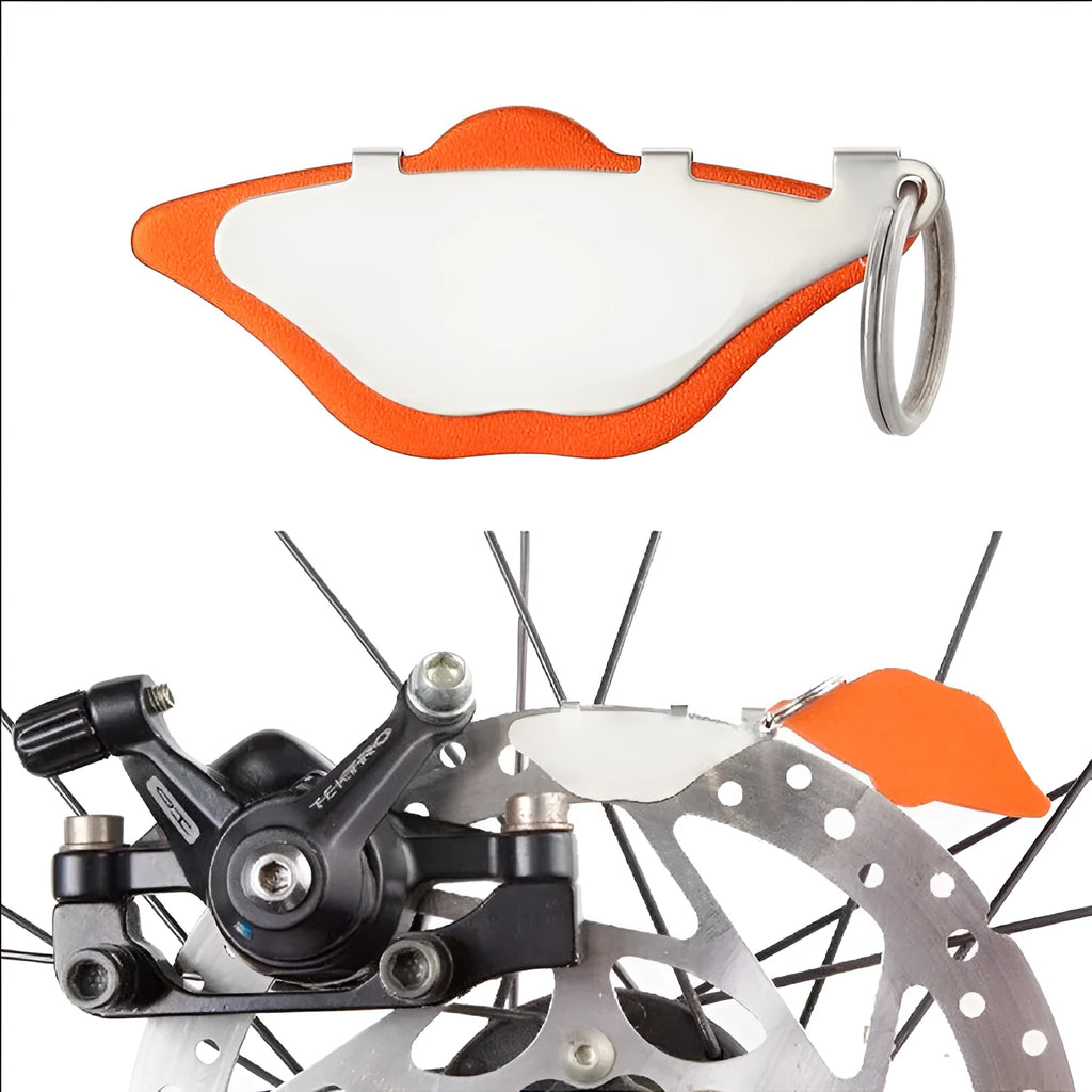Mountain bike disc brake linings replacement pads in black and orange with adjustment flap