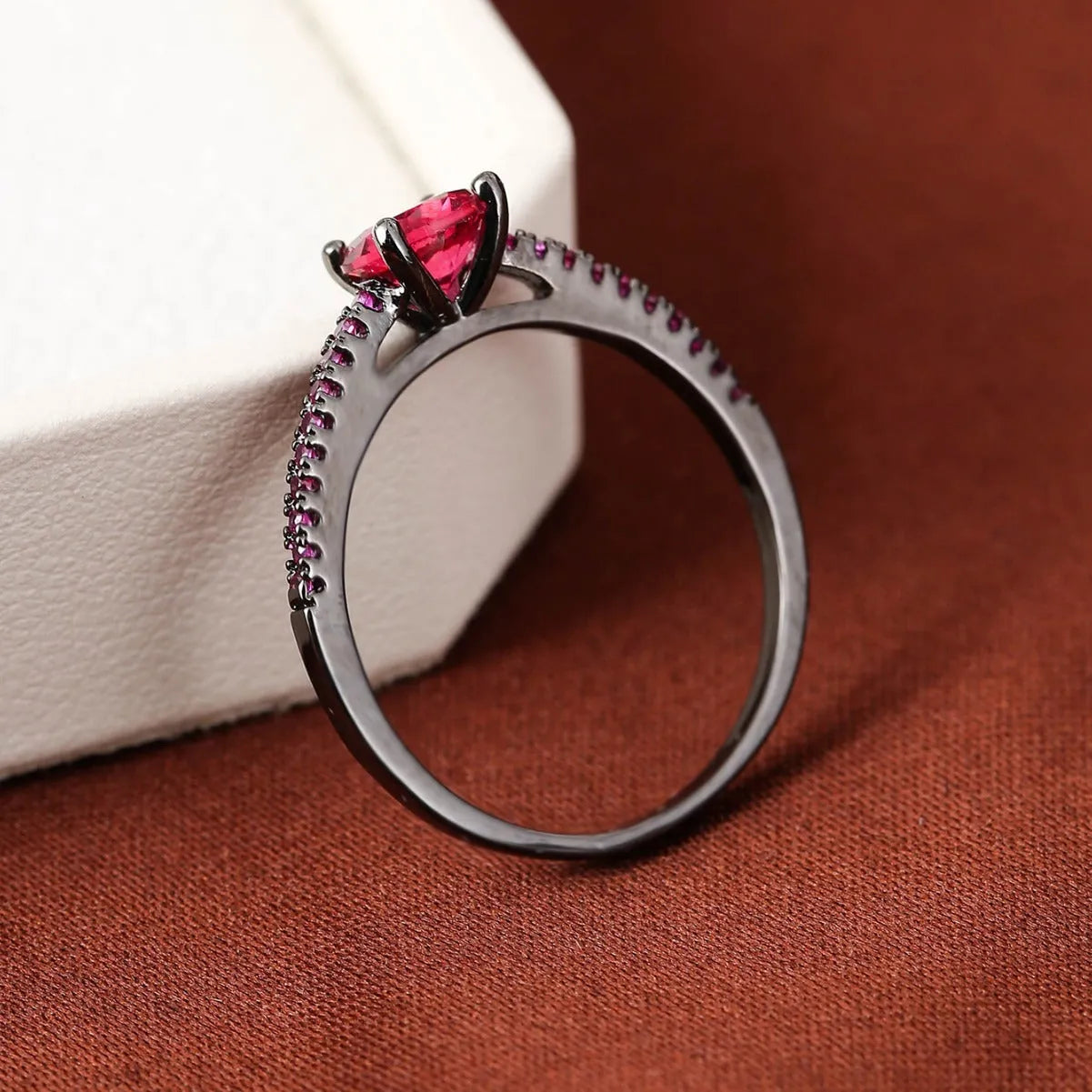 A hexagonal zircon fashion ring made from copper, shown in an electroplated gold rose red finish.