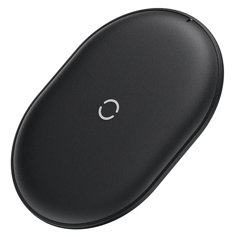 Baseus Rough 15W wireless charging pad in black on a desk next to a mobile phone.