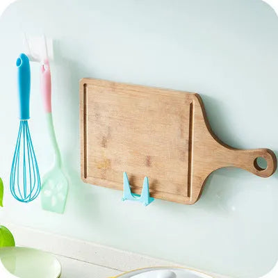 Wall-mounted PP plastic kitchen lid holder in blue, green or white, stuck inside a cabinet for lids and utensils.