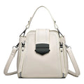 Soft textured PU leather ladies handbag in a square vertical shape with sewn thread detailing.