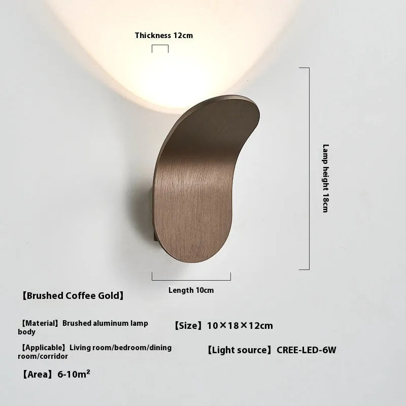 Modern simple wall lamp in brushed gold finish mounted on living room wall