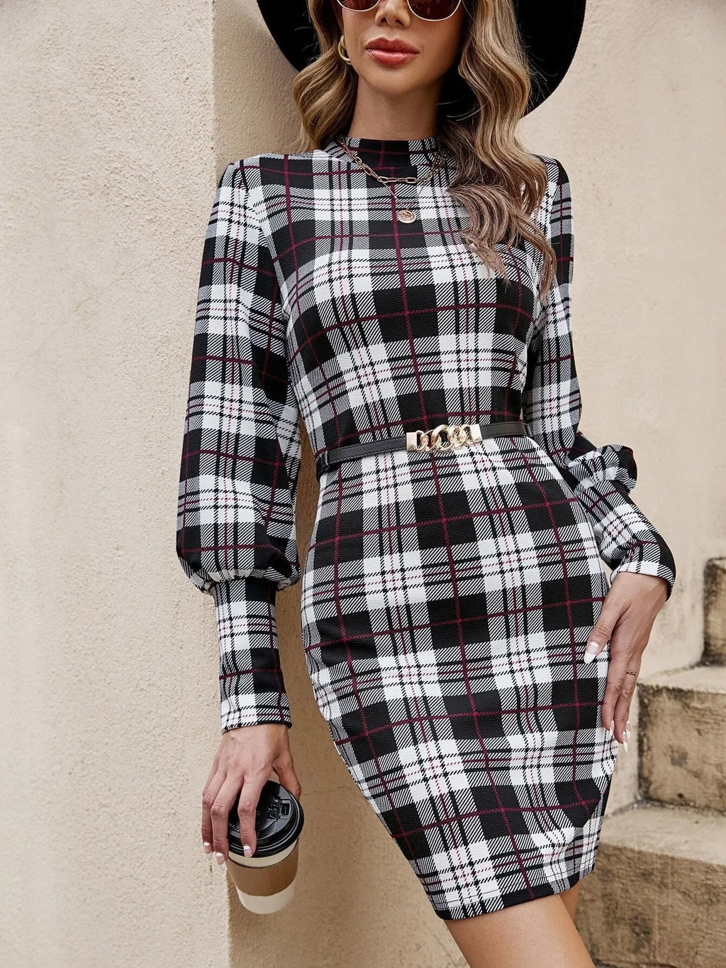 A black tight-fitting midi dress with voluminous lantern sleeves and leather stitch detailing.