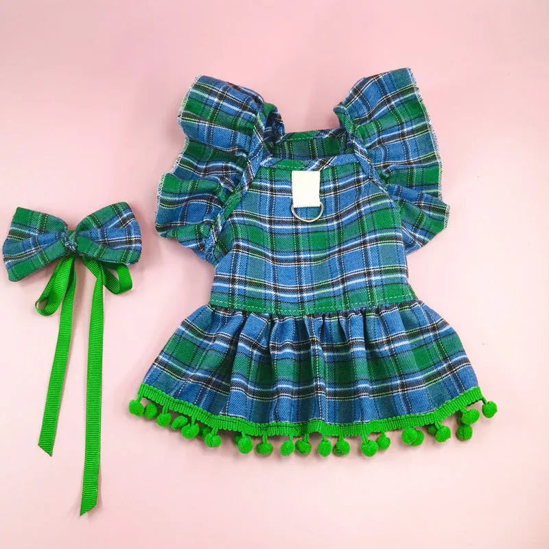 Red tartan Christmas skirt with bow tie and head flower on a dog, showing universal pet festive clothing.