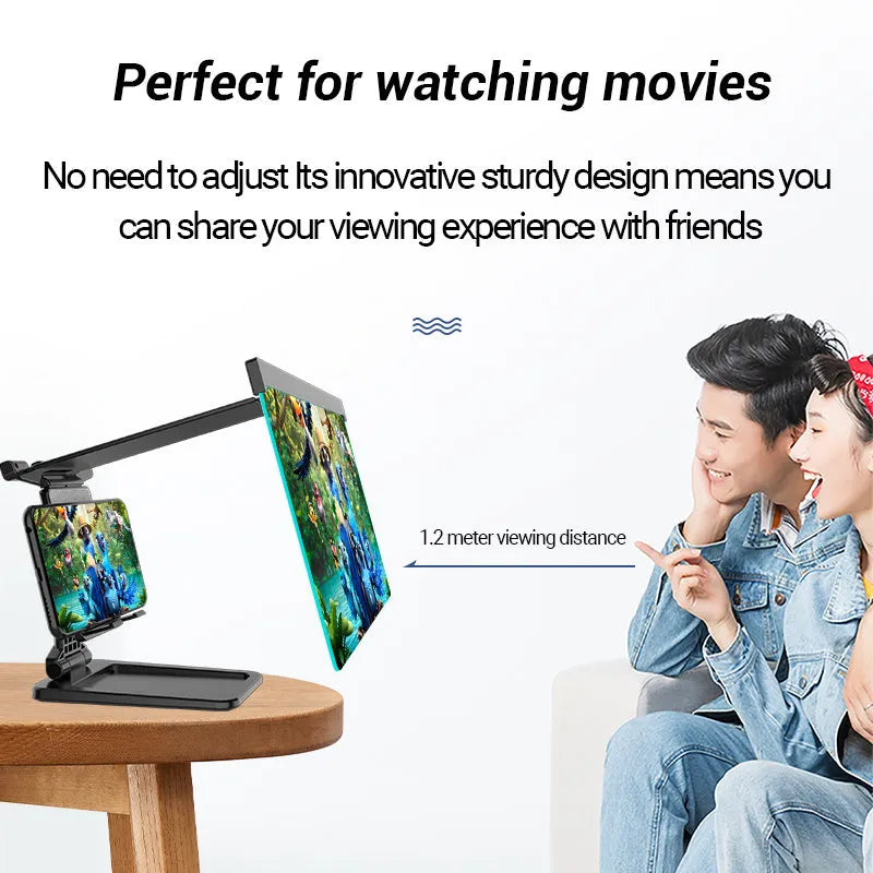 Black foldable mobile phone screen amplifier with a detachable phone holder on a desktop.