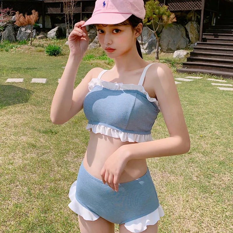 Women's solid colour one-piece swimsuit with suspender straps, designed for swimming.