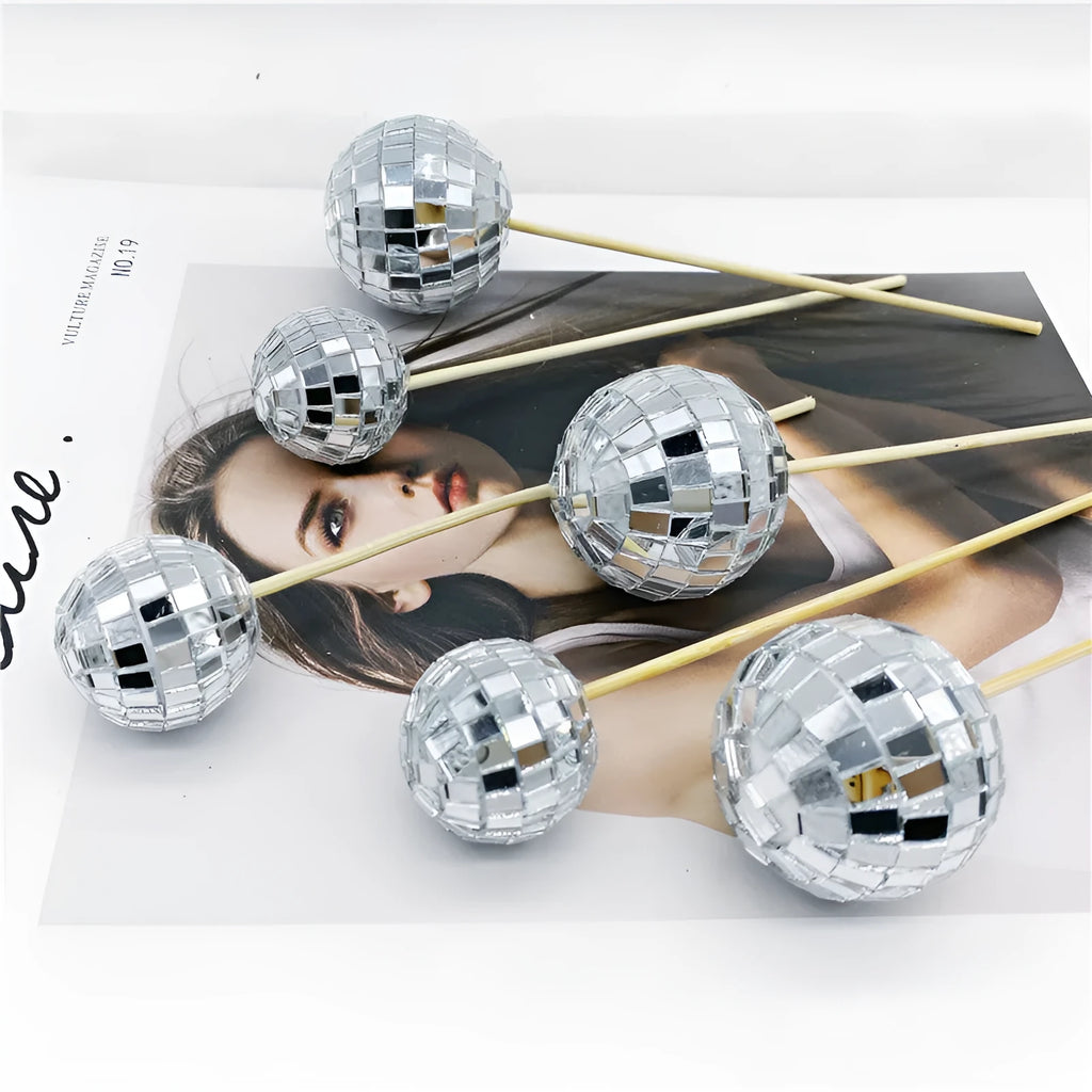 Glass mirrored disco ball cake decoration on a wooden stick, shown in different sizes.