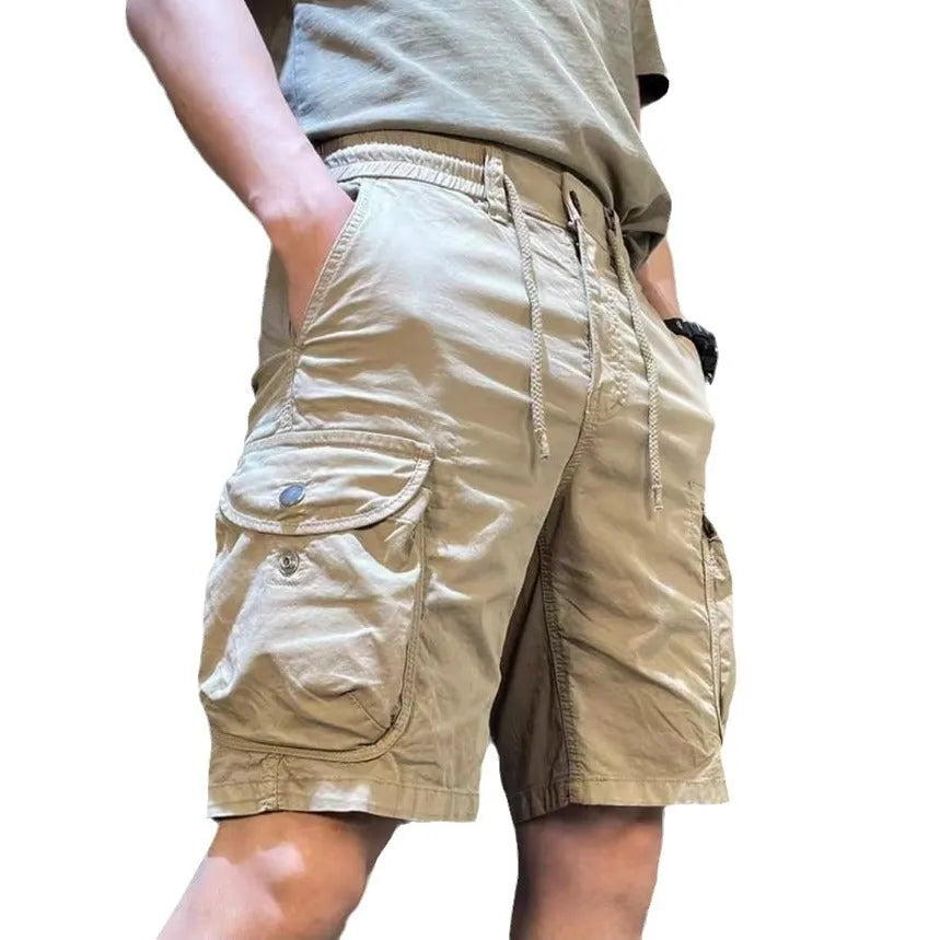 Loose straight-leg casual overalls trousers with multiple pockets in khaki colour.