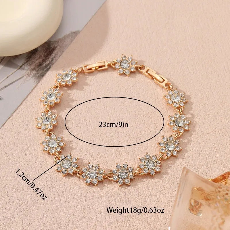 Women's floral charm bracelet in gold or silver electroplate with coloured gemstone effects.