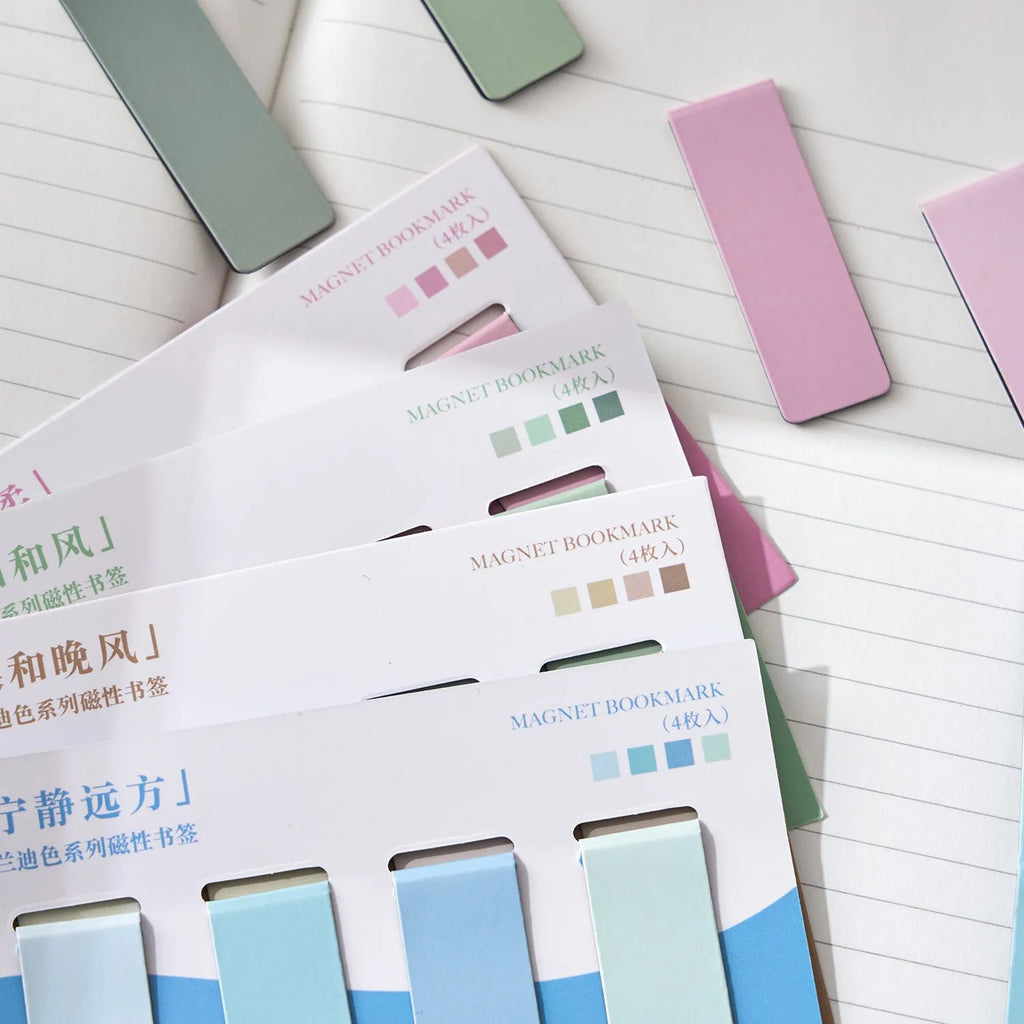 Set of four magnetic morandi colour block bookmarks in soft pastel hues on a page