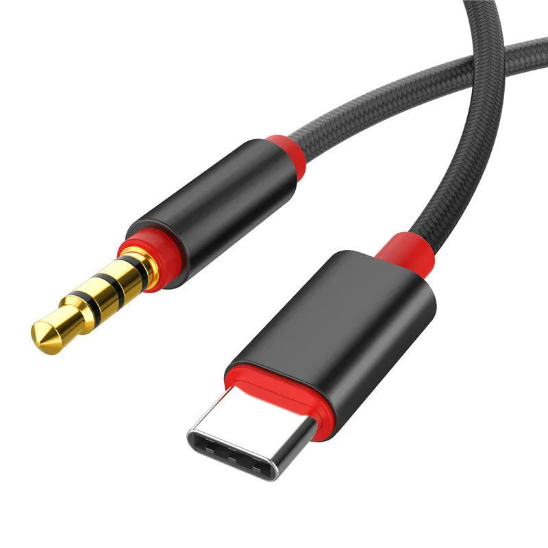 Silver nylon-braided audio cable with 3.5mm plugs and a car adapter connector.