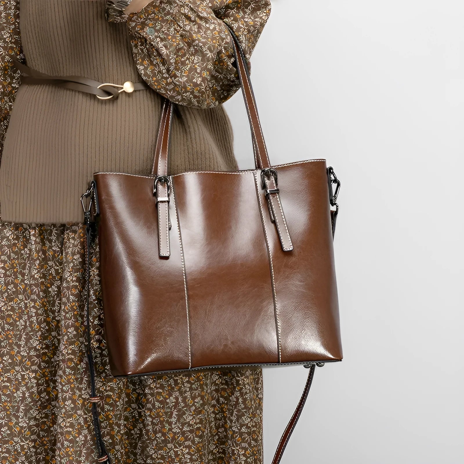 Brown genuine leather retro women's tote bag with multiple zipper pockets and three shoulder straps.