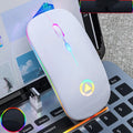Ultra-thin mini wireless mouse in metallic grey with colourful breathing glow on a desk