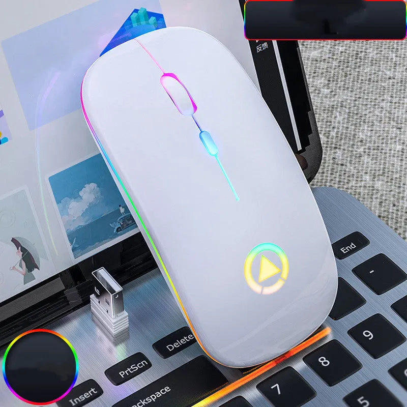 Ultra-thin mini wireless mouse in metallic grey with colourful breathing glow on a desk