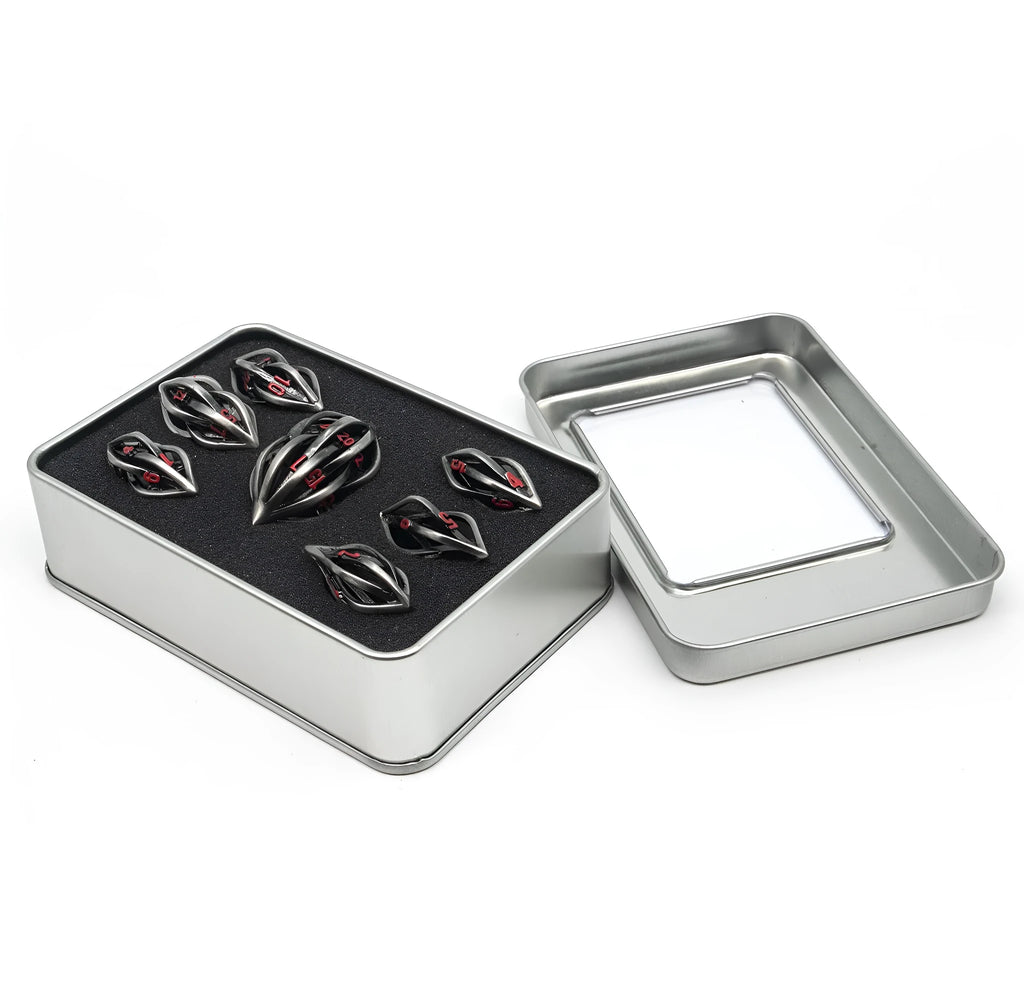 Seven metal melon seed shape dice in antique silver with coloured characters on a surface