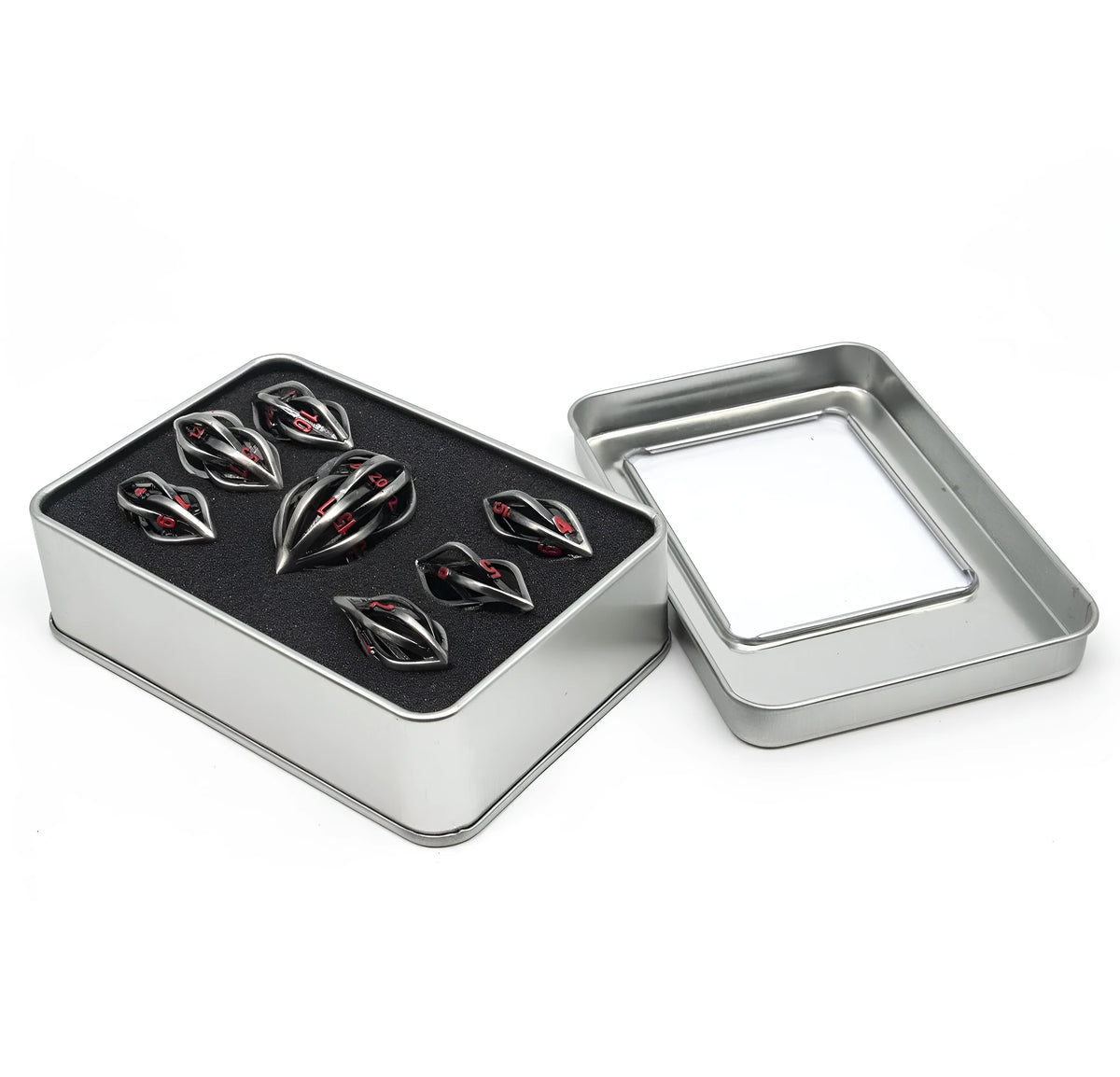 Seven metal melon seed shape dice in antique silver with coloured characters on a surface