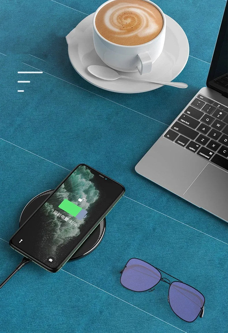 Black Kuulaa KL-CD16 wireless disc phone charger on a surface with LED light on.