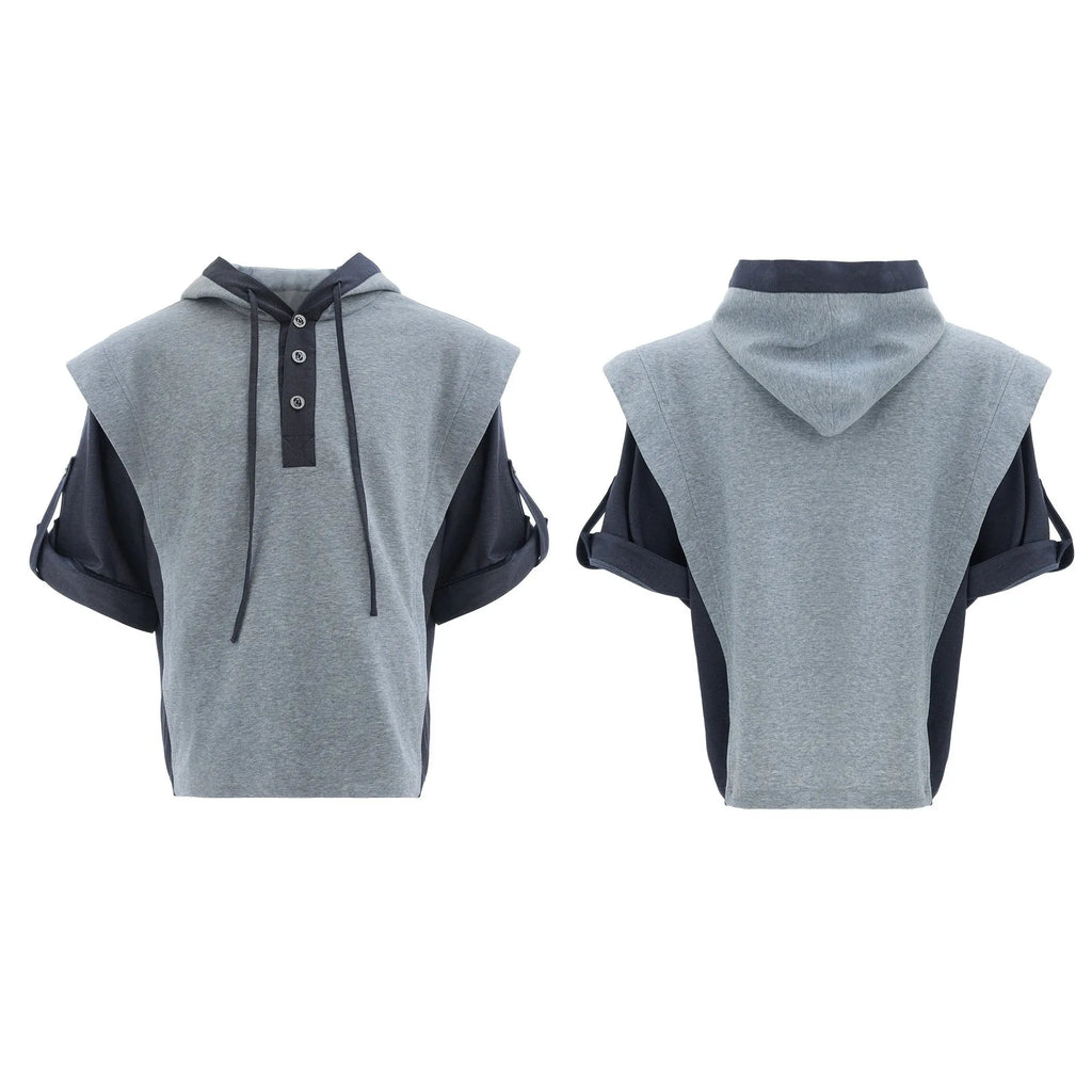 Man wearing a grey hooded short-sleeve sweatshirt and matching trousers with three-dimensional stitching detail.