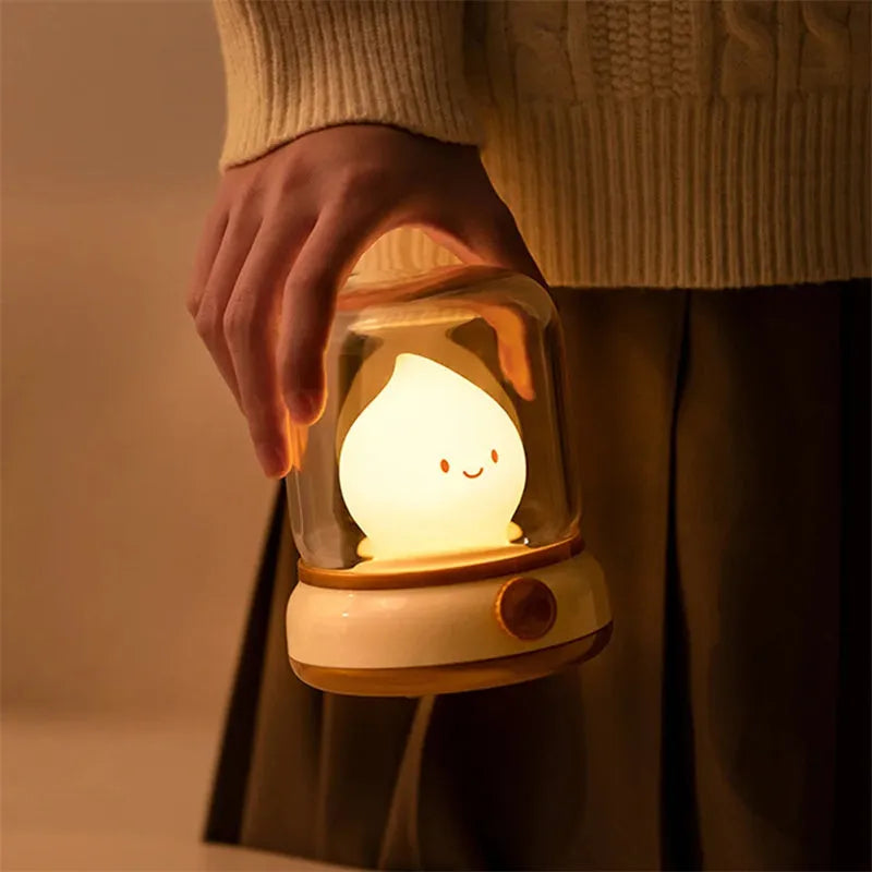 Green retro oil lamp design USB rechargeable LED desk night light on a wooden table.