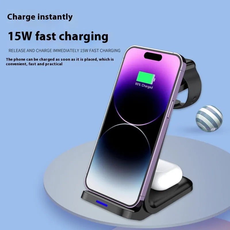 Three-in-one 15W wireless charger vertical stand in black, charging a smartphone and accessories