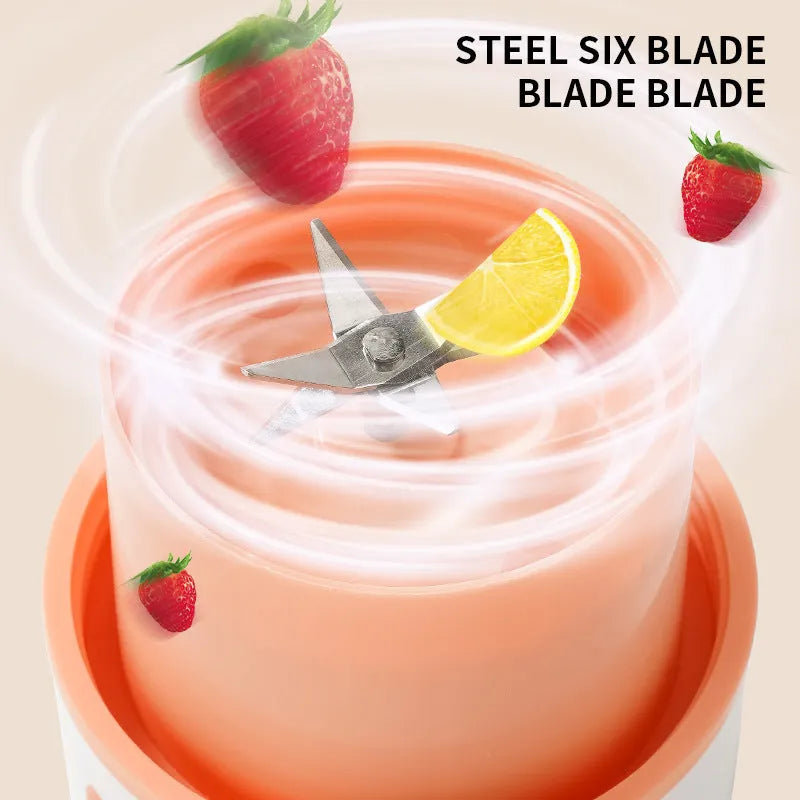 Portable electric juicer with USB charging cable next to 400ml plastic blending cup