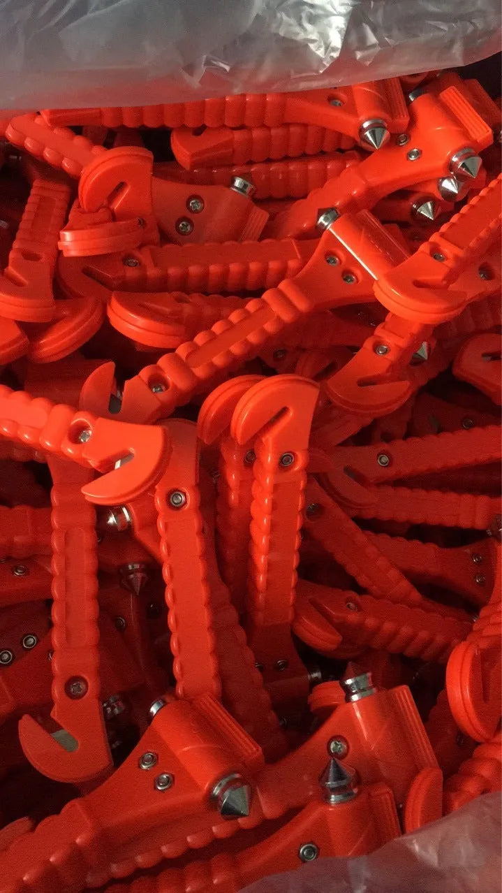 Red car emergency hammer with integrated seatbelt cutter and window breaker tip