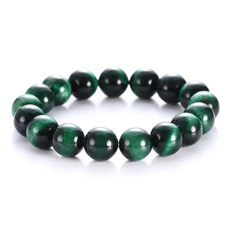 Green Tiger Eye stone beaded bracelet with polished geometric beads on a white background.