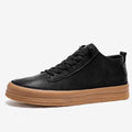 Men's black leather casual shoes with round toe, flat heel, and laced closure on soft rubber sole