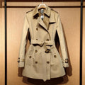 Khaki double-breasted trench coat for women with flight sleeves and button details.