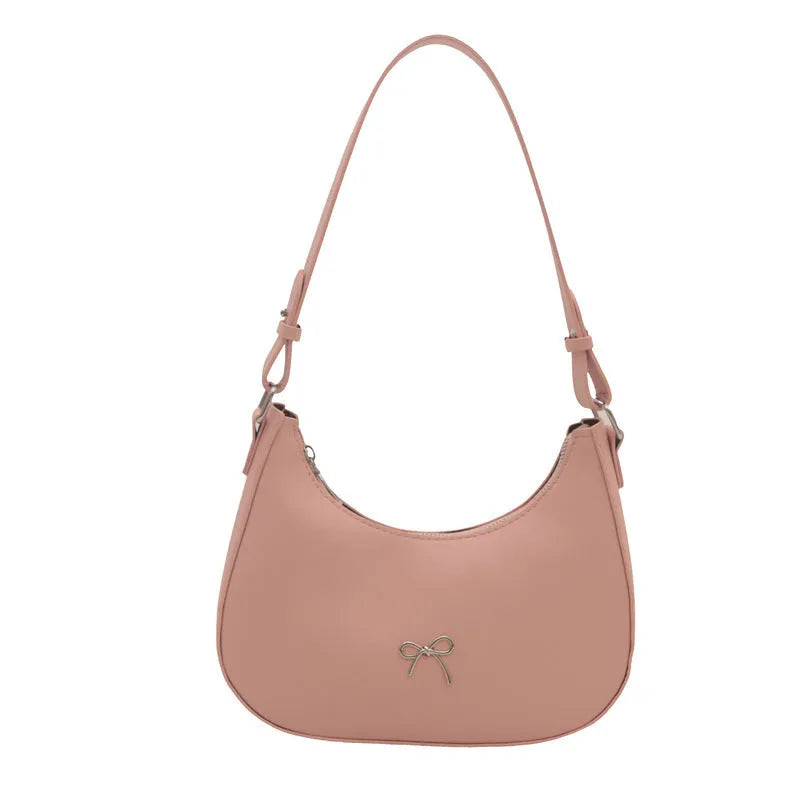 Small dumpling-shaped PU leather shoulder bag for women in multiple colours, showing the single strap and external pocket