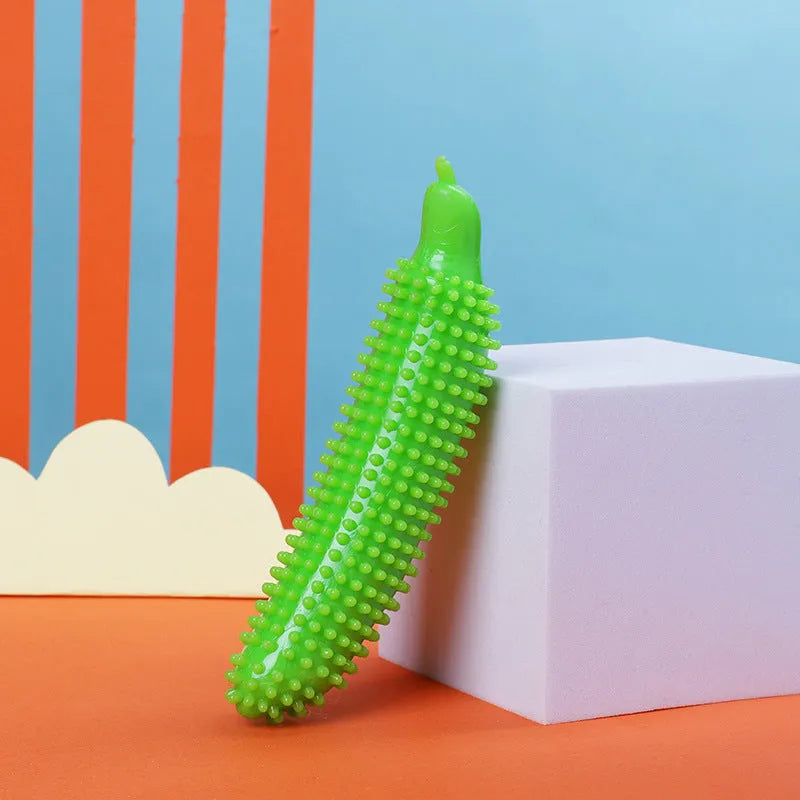 Green cucumber-shaped dog chew toy for teething and interactive play.