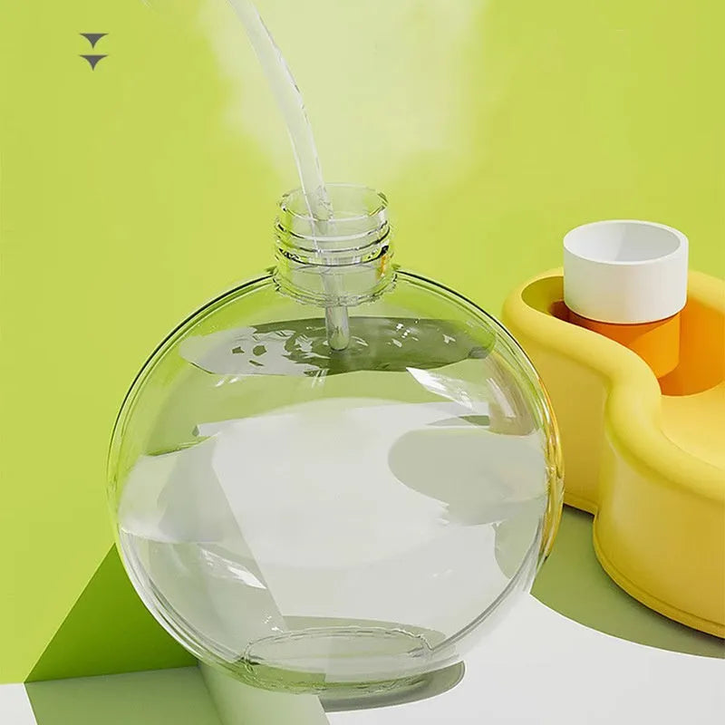 Green portable dog travel cup with pull-out water bowl and bottle handle.