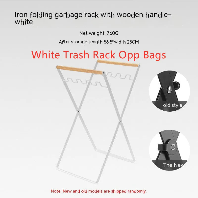 Black iron folding bin rack with wooden handles holding two rubbish bags in an outdoor setting.
