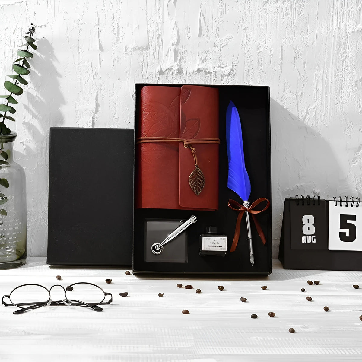 Feather dip pen gift set with natural quill, copper pen, ink, wax seal, acrylic stand and antique book in a box.