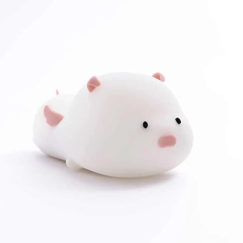 Blue silicone pig-shaped night light with USB charging port