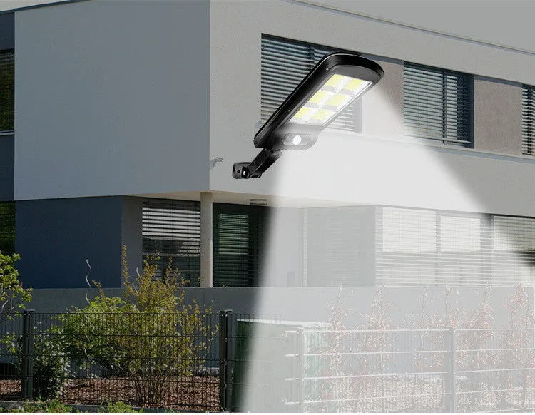 Black solar-powered outdoor security light with motion sensor on a wall