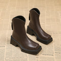 Black platform Martin boots for women with square toe, back zipper, and a high rubber sole.