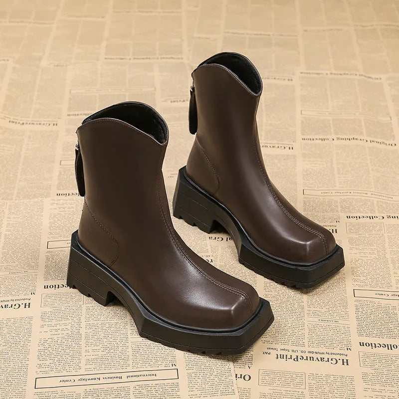Black platform Martin boots for women with square toe, back zipper, and a high rubber sole.
