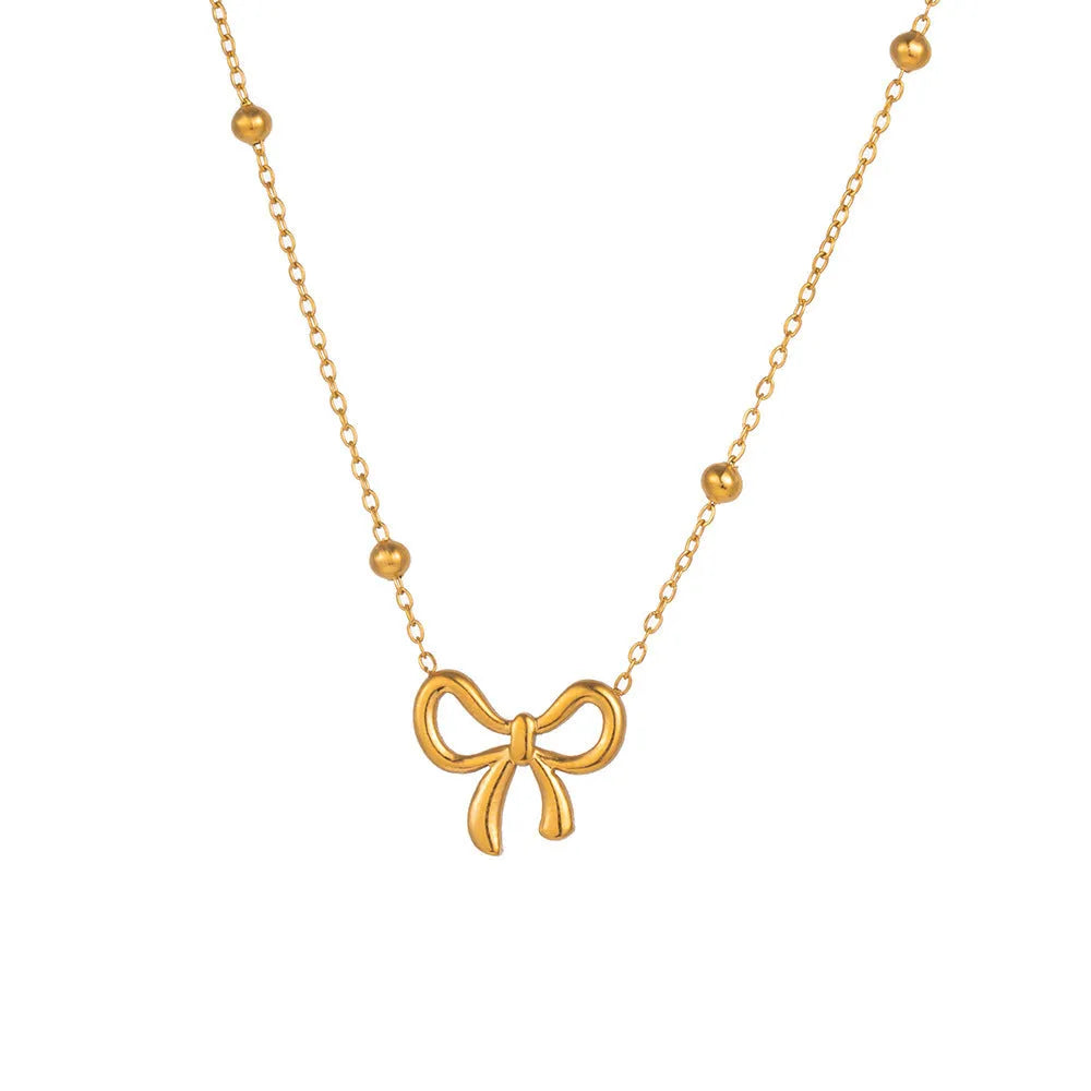 Gold electroplated bow necklace with adjustable 41-50cm length and cross chain