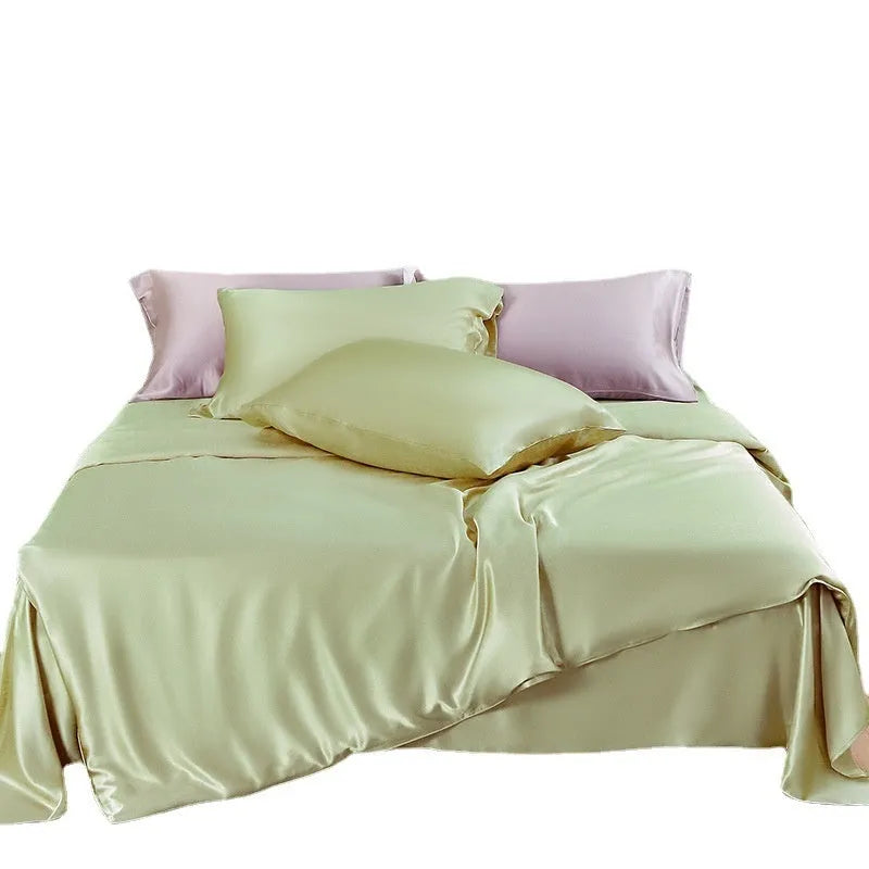 Double-sided silk duvet cover in plain weave, shown in one of six solid colours, laid flat on a bed.